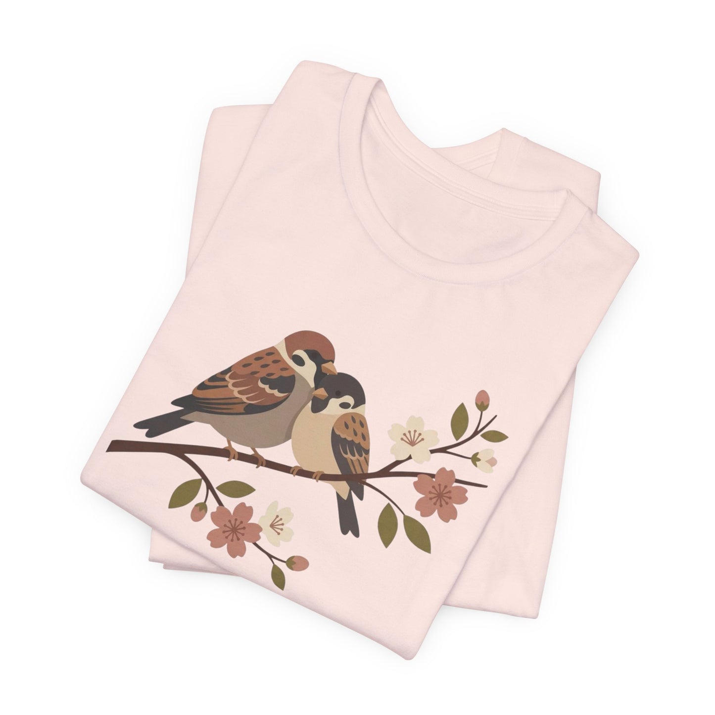 Folded pink fabric with bird and floral design on a white background