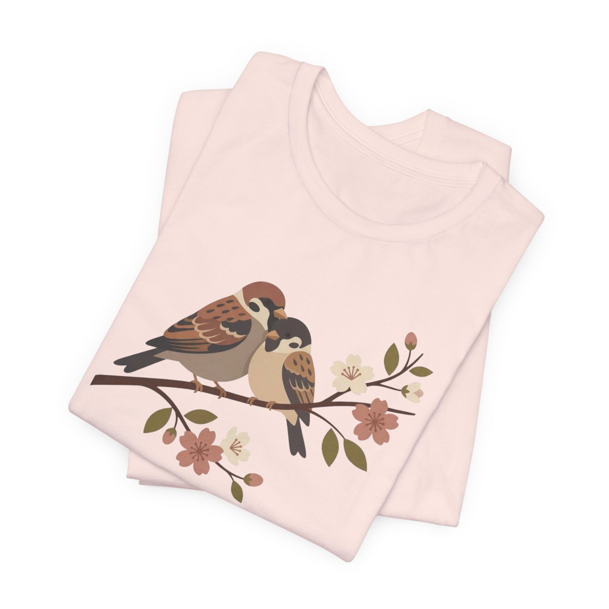 Folded pink fabric with bird and floral design on a white background